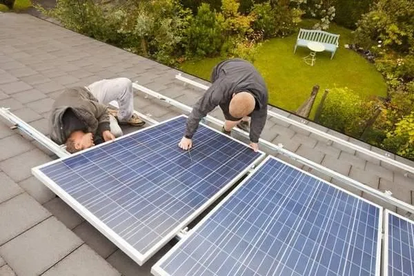 Mężczyźni pracujący na dachu przy fotowoltaice